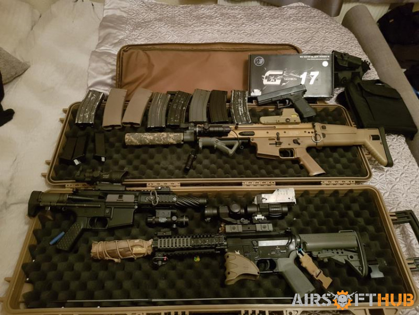 A bundle of guns and clothing - Used airsoft equipment